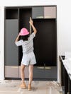 woman measuring cabinets
