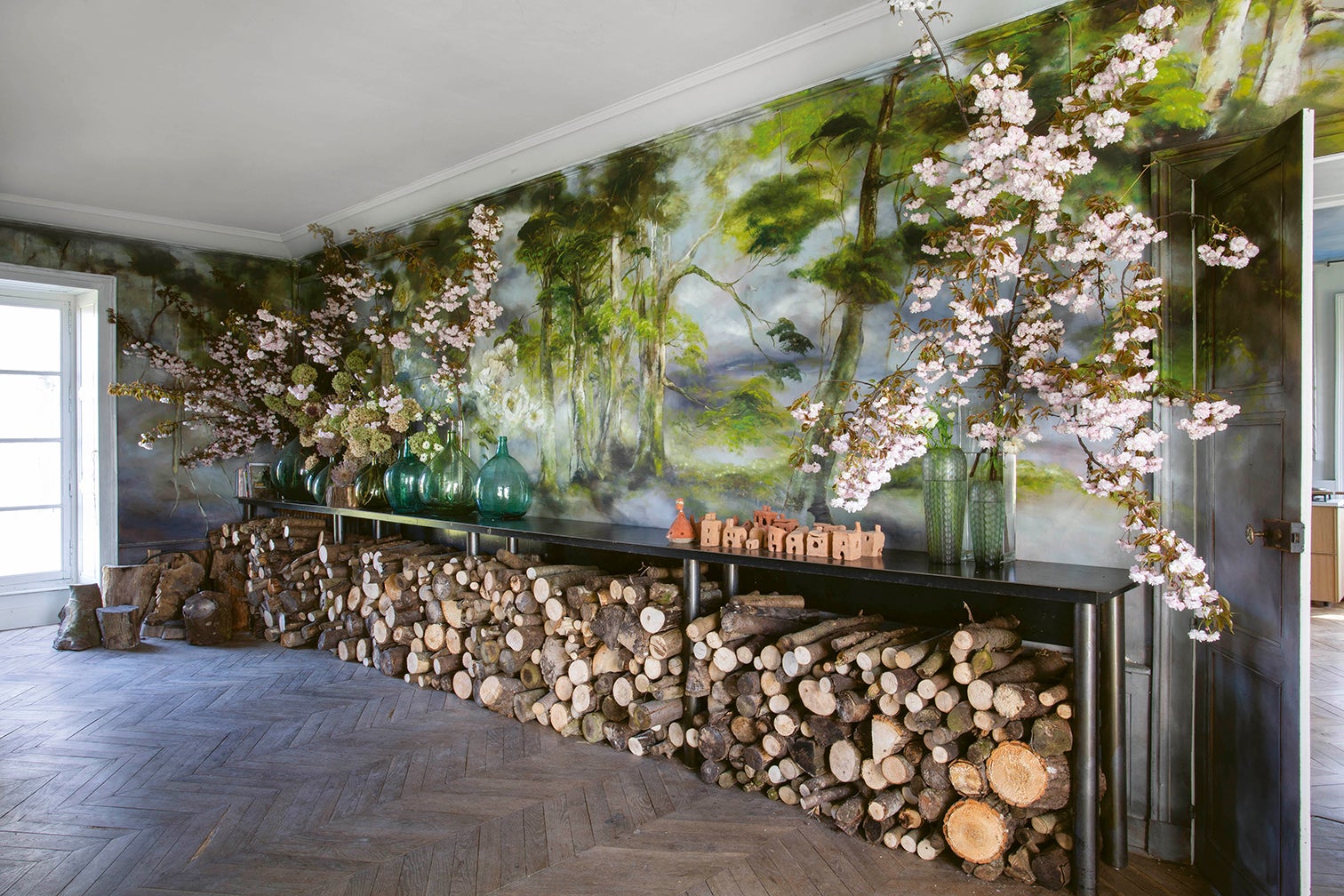 Room with painted mural and chopped wood
