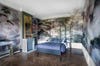 Bedroom with painted mural and branches