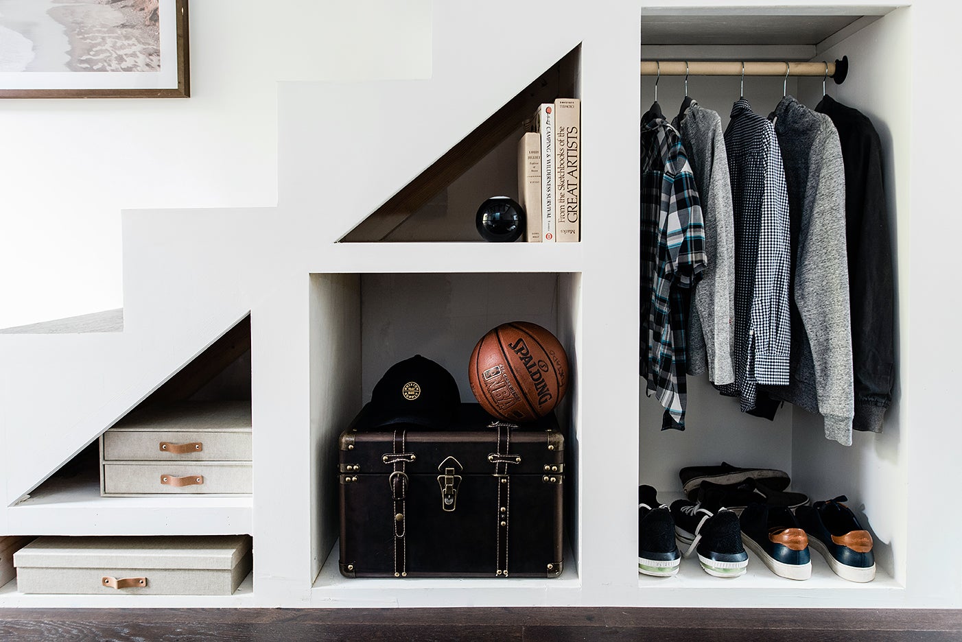 Storage under stairs in a teen's tiny loft backyard house.
