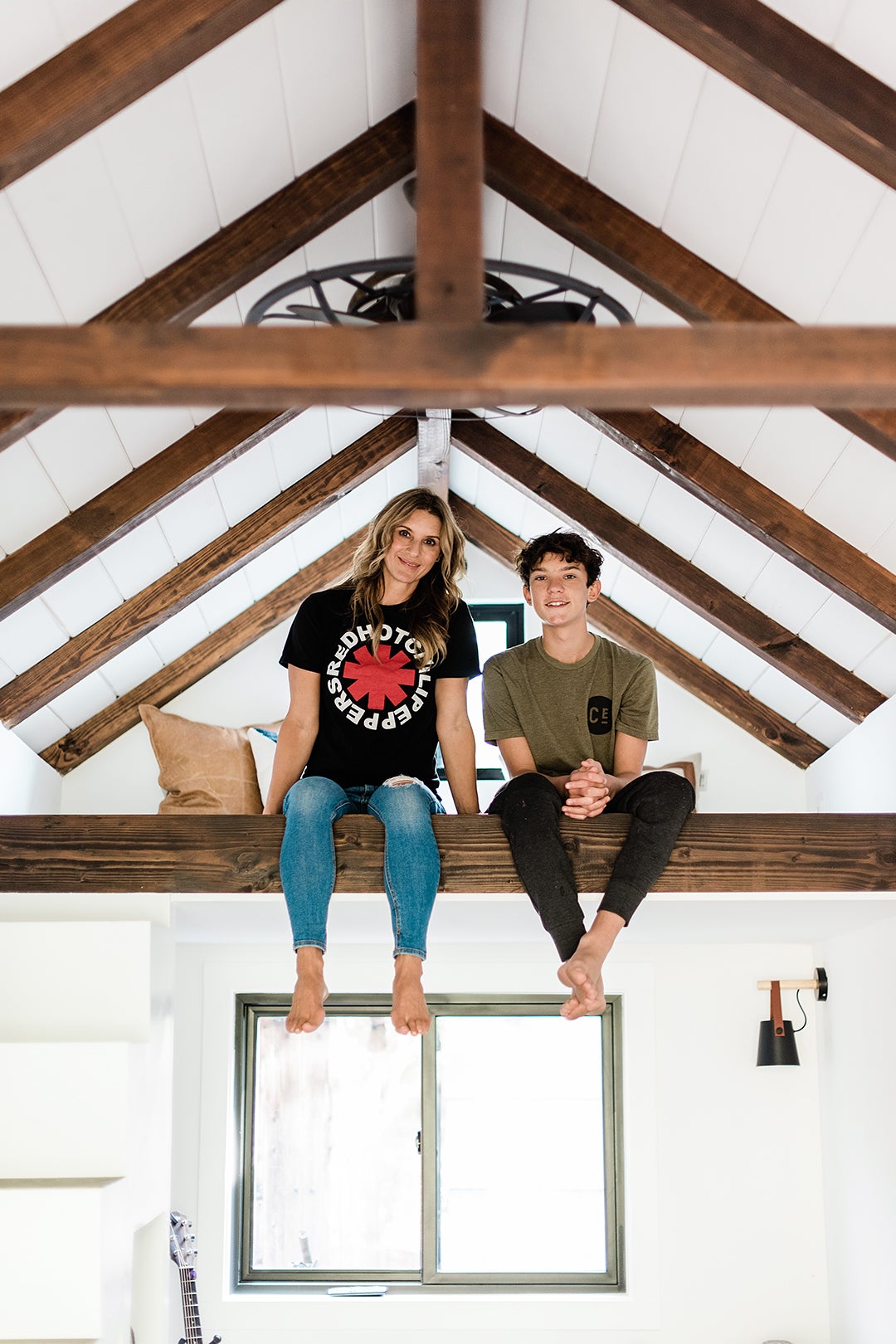 Designer Lisa Furtado and her teen son Mason sitting in the airy bunkhouse they built together.