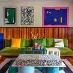 pea green velvet sofa in colorful living room