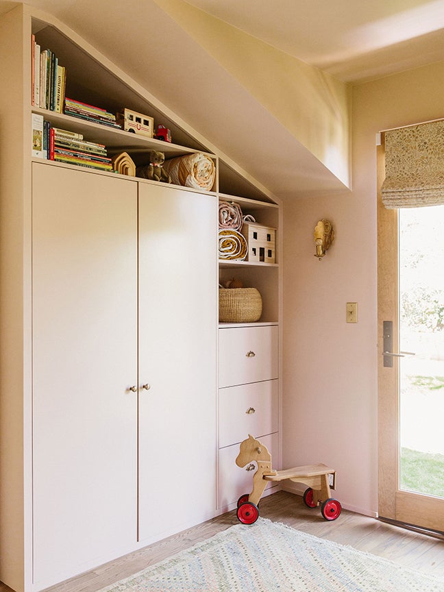 Powder pink built-in cabinets in an L.A. nursery.