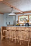 wood kitchen island with pale blue cabinets