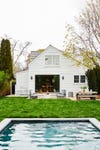 white clapboard house exterior with pool