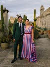 bride in pink and blue striped dress and groom in suit