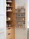 kitchen cabinet with wood spice rack on door