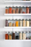 jars of spices on white shelves