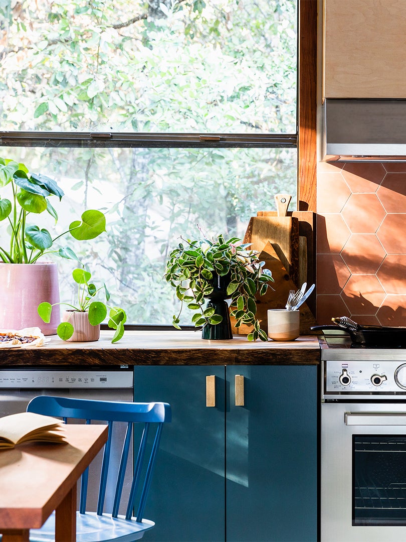 blue kitchen cabinet under big window