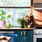 blue kitchen cabinet under big window