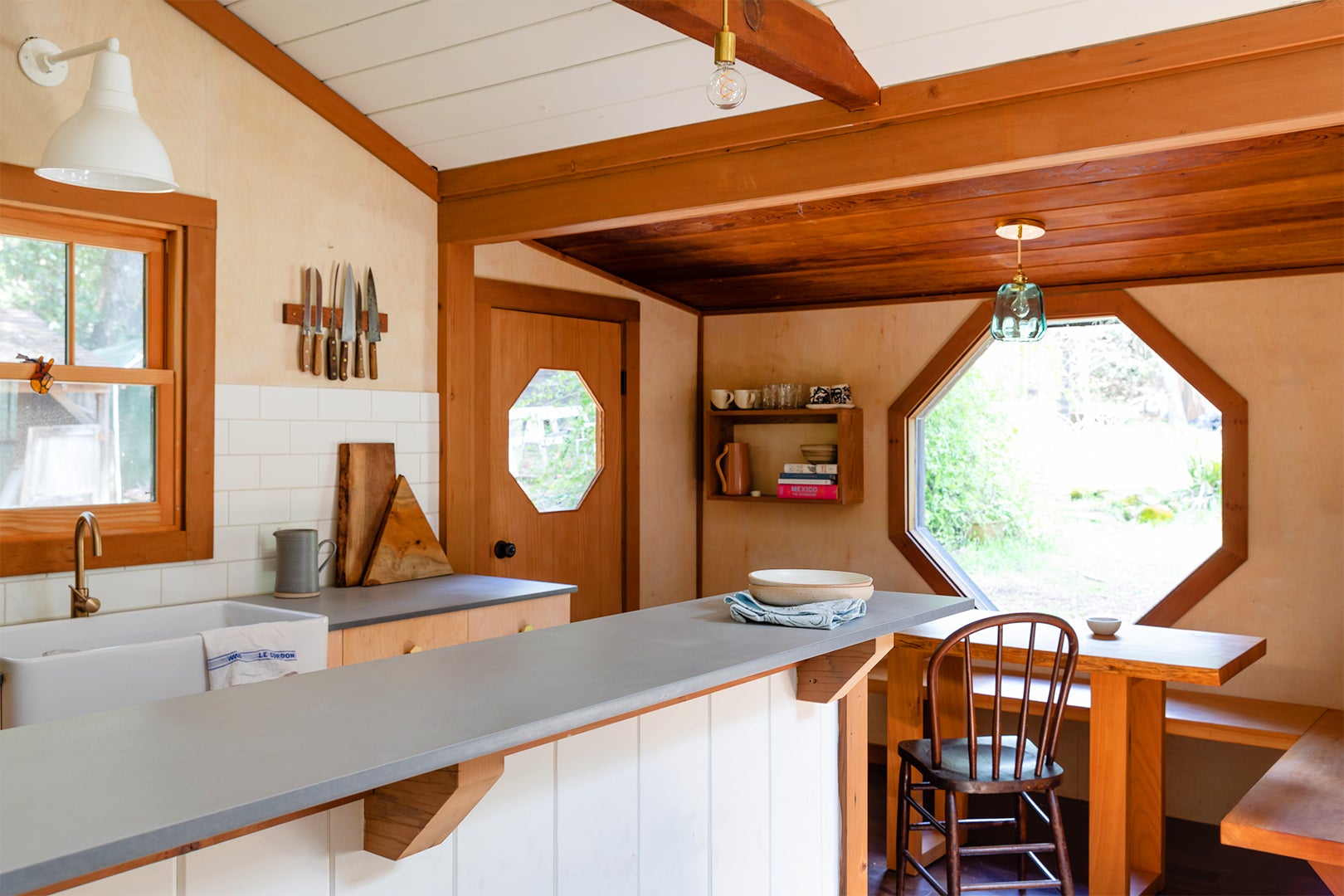 kitchen facing breakfast nook with octagonal window