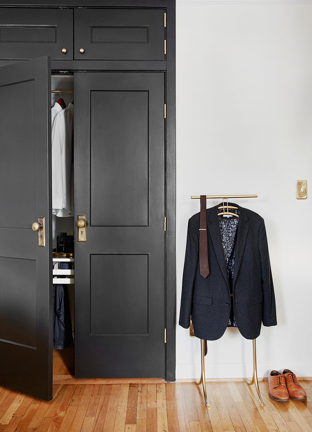 mans suit next to black closet