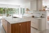 white kitchen with slatted wood island