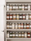 spices lined up on door
