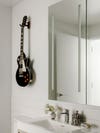 guitar hanging in bathroom