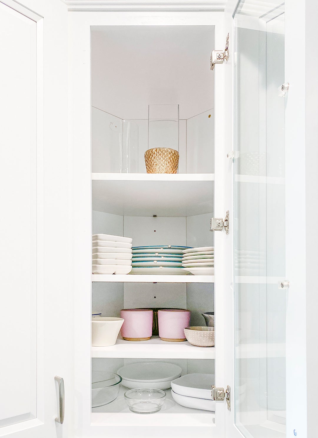 white corner cabinet with glass door