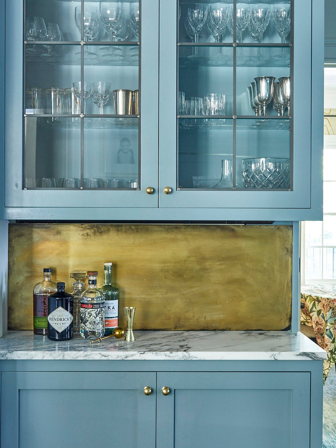 sky blue kitchen bar with brass backsplash