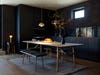 black kitchen with wood dining table