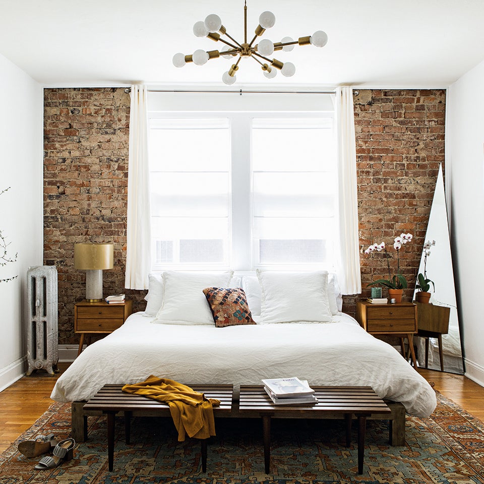 bedroom with exposed brick wall