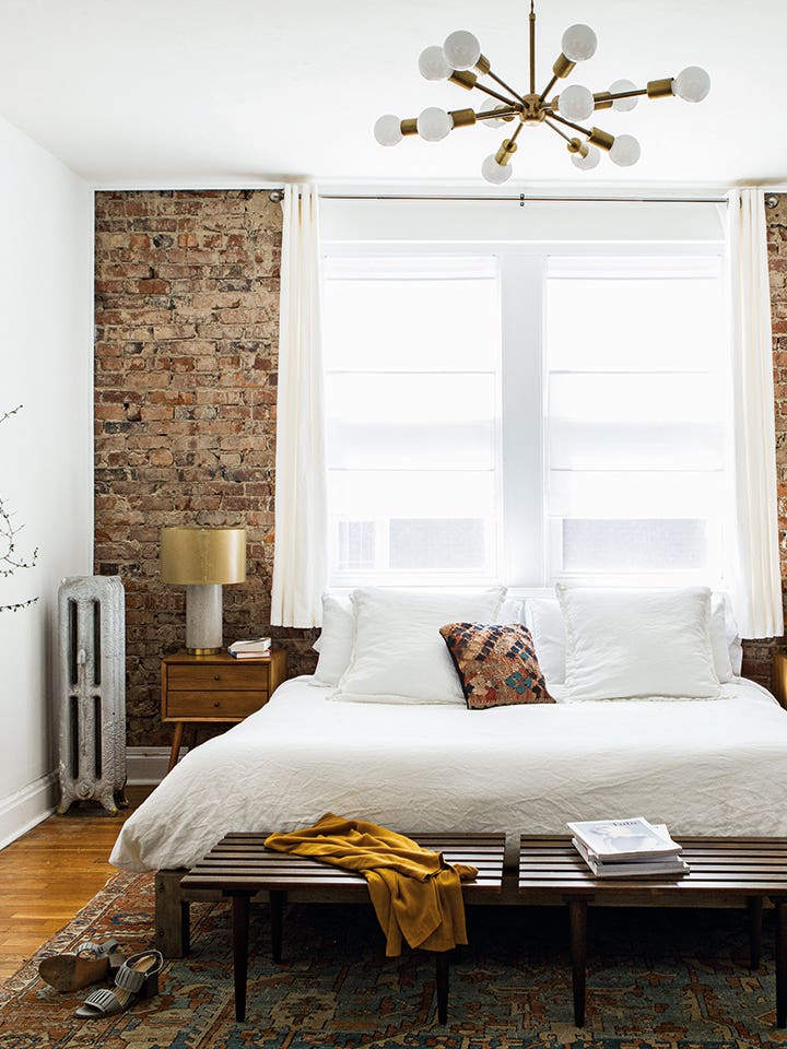 bedroom with exposed brick wall