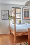 four poster bed with plants hanging from it