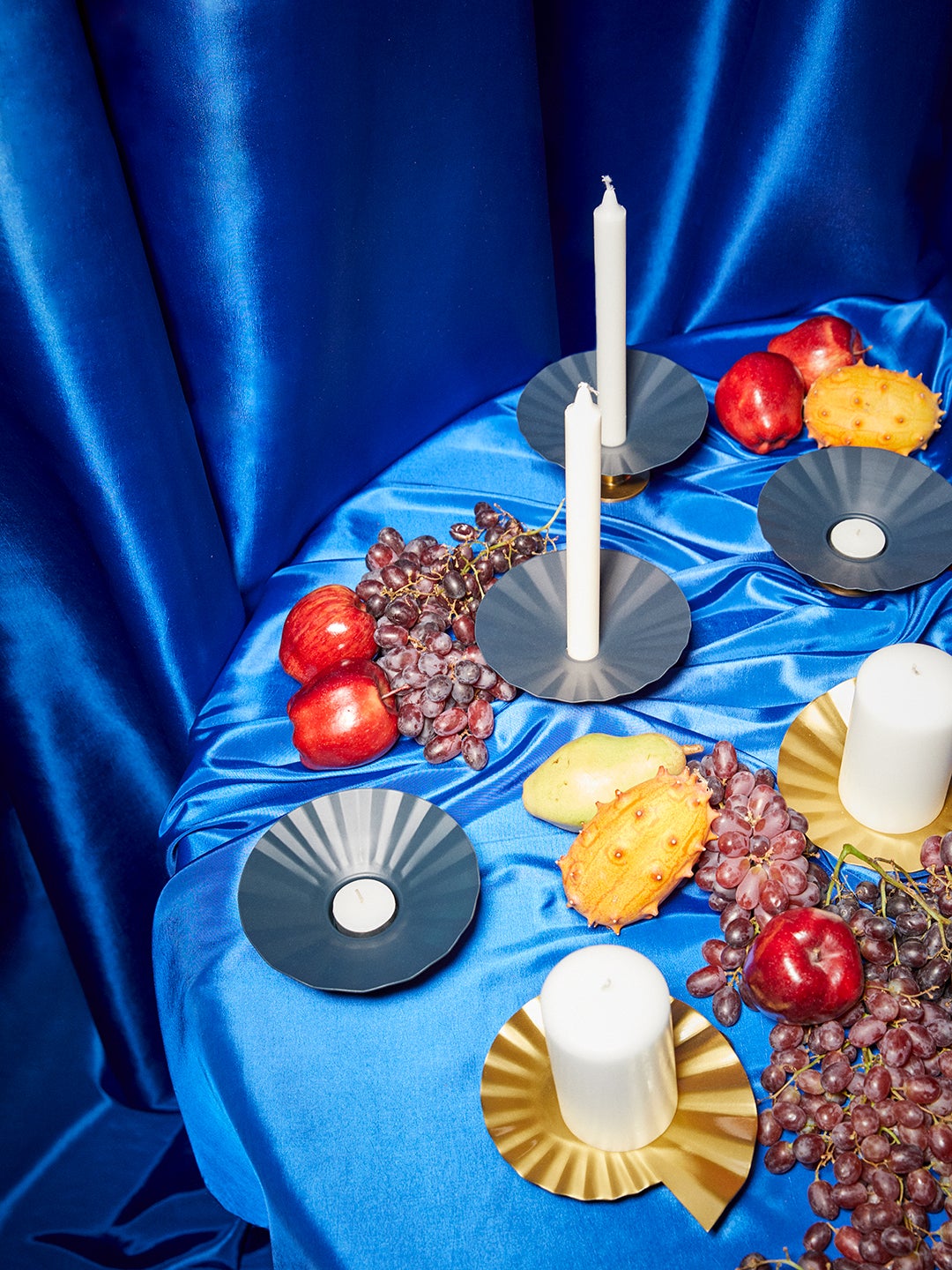 a tablescape with blue tablecloth and candlesticks