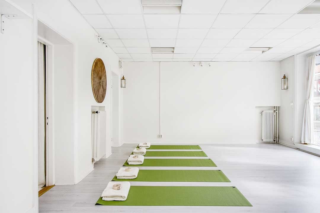 green yoga mats in white studio