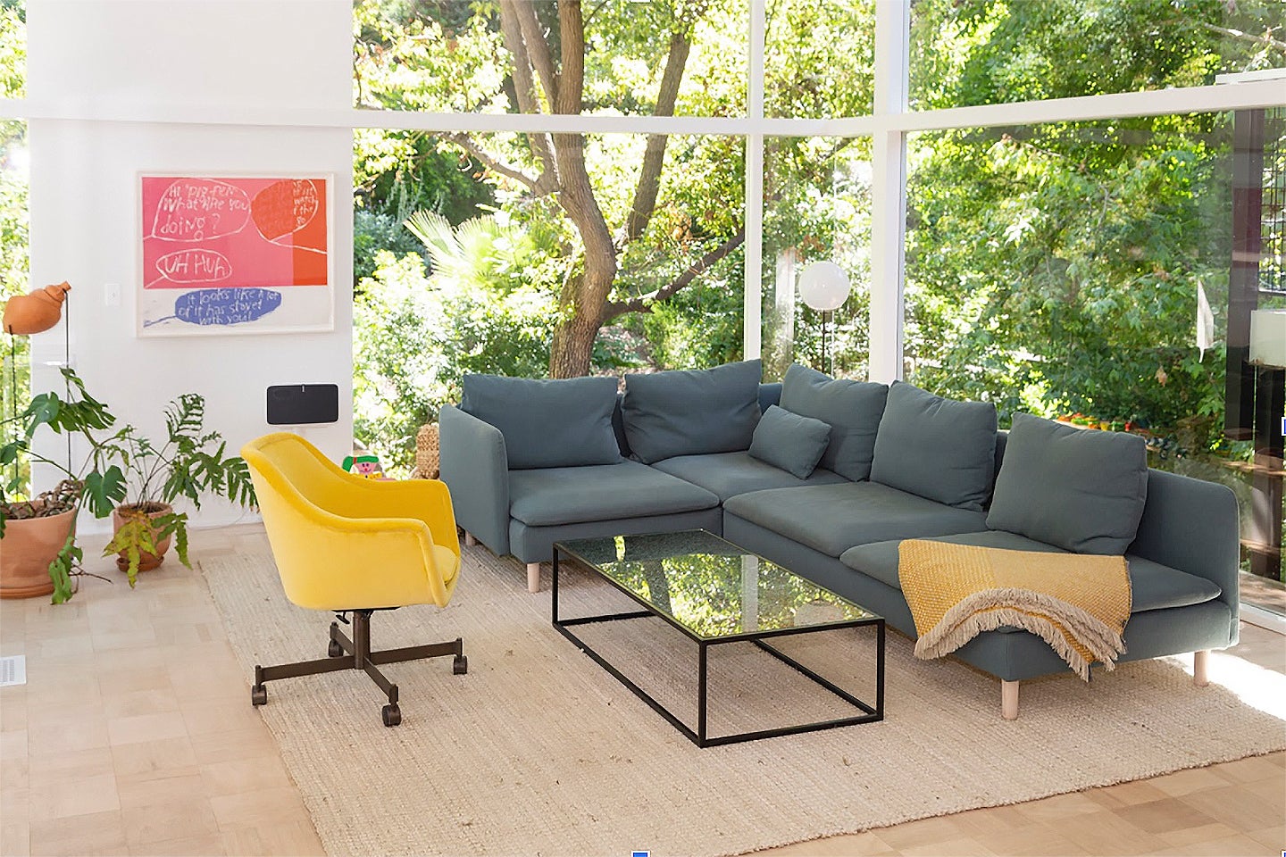blue corner sofa, jute rug and yellow chair