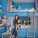 woman holding kid on bunk bed