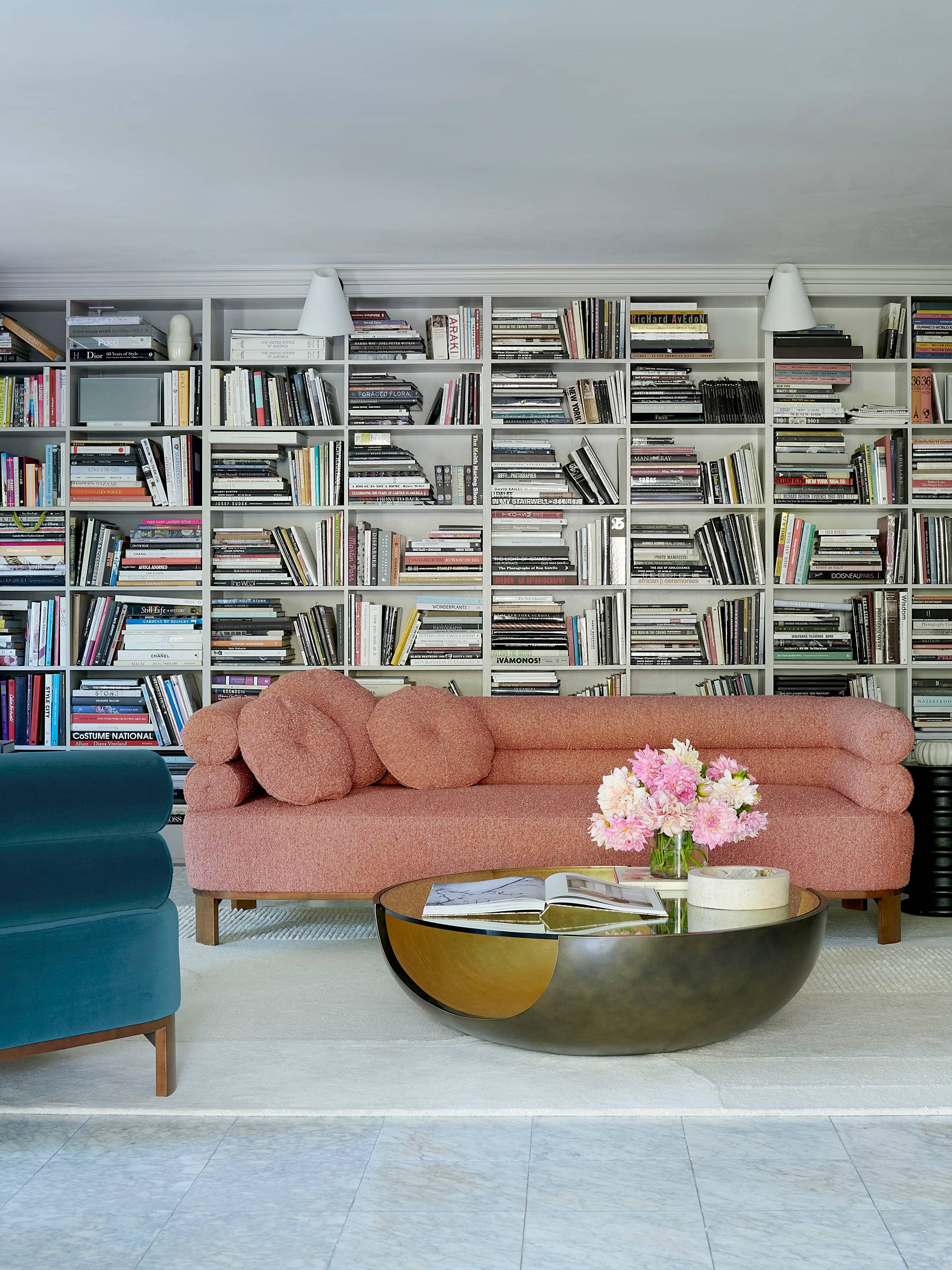 library with pink sofa