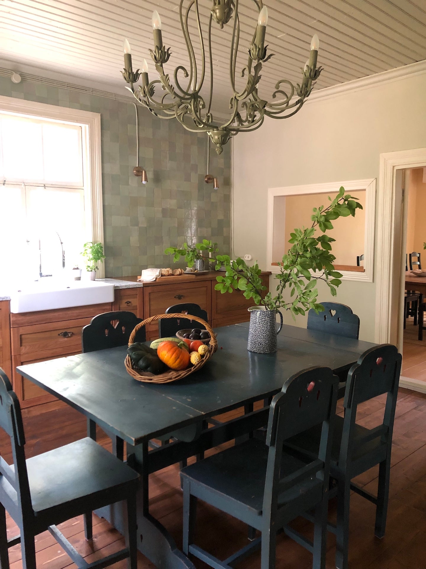 black kitchen table and green chandelier