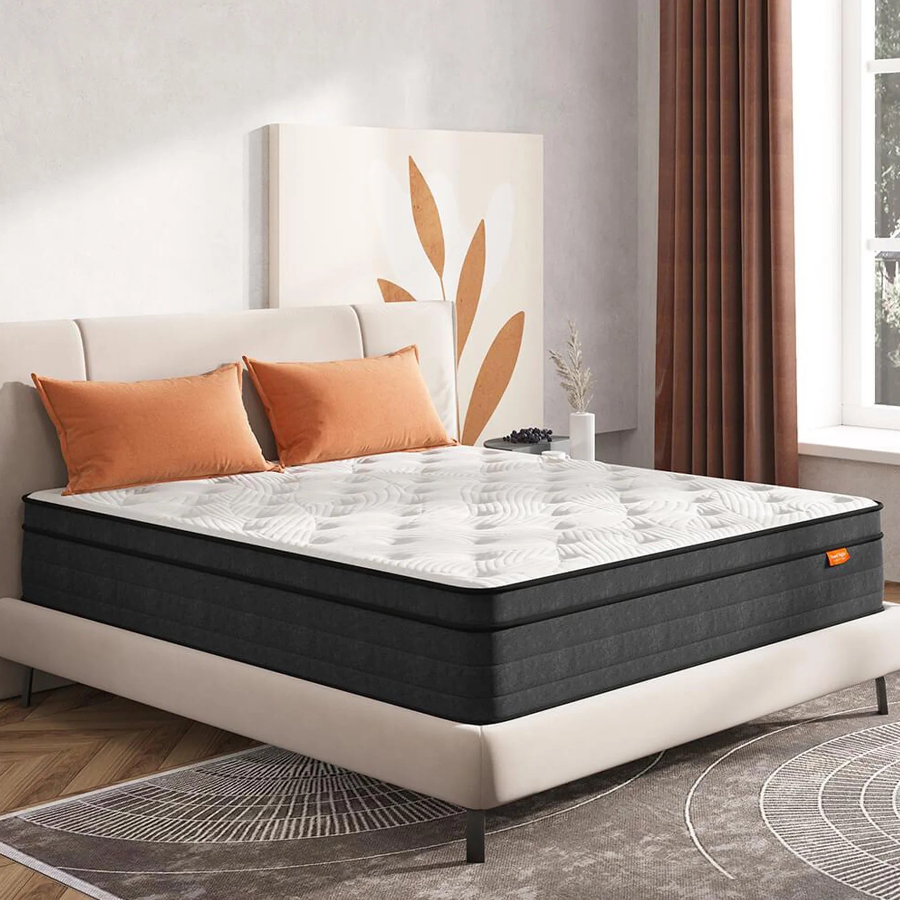 Hybrid mattress with orange pillows