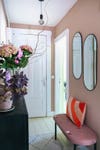 entry way with bench and pink walls