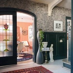 entry way with swirled wallpaper