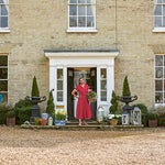 Paula Sutton in front of her home in the country