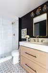 Black Accent Wall Bathroom with Marble Shower Tile and Wood Vanity