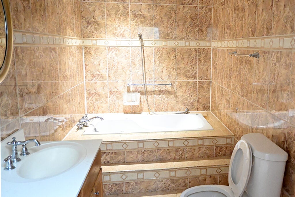 dated yellow tiledbathroom
