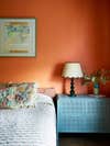 orange bedroom and blue side table