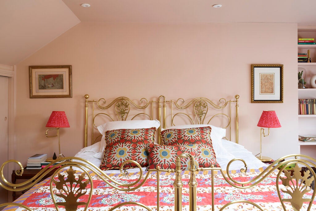 light pink bedroom with gold metal bed frame