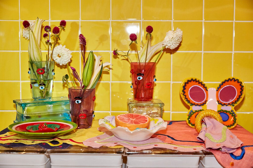 tablescaping, yellow tiles on wall, glasses, small bowls and tablecloths  