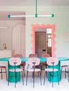 Pink dining chairs around custom dining table 