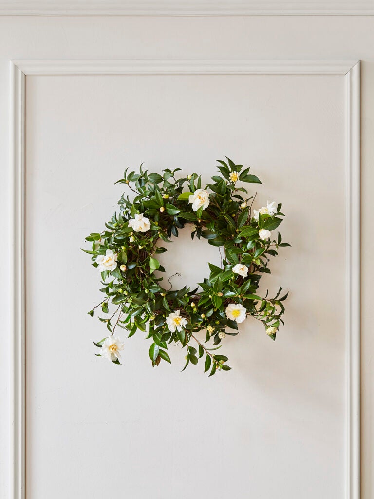 green wreath with white flowers