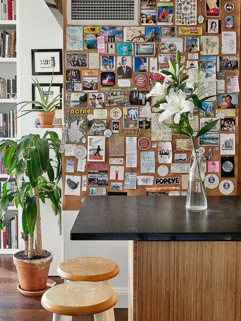 kitchen space with wall covered with cards and photos