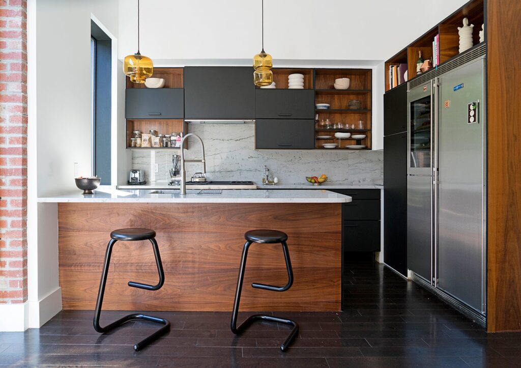 Metal black bar stools in Tortuga Living's black, white, and wood kitchen 