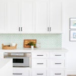 white kitchen with green backsplash