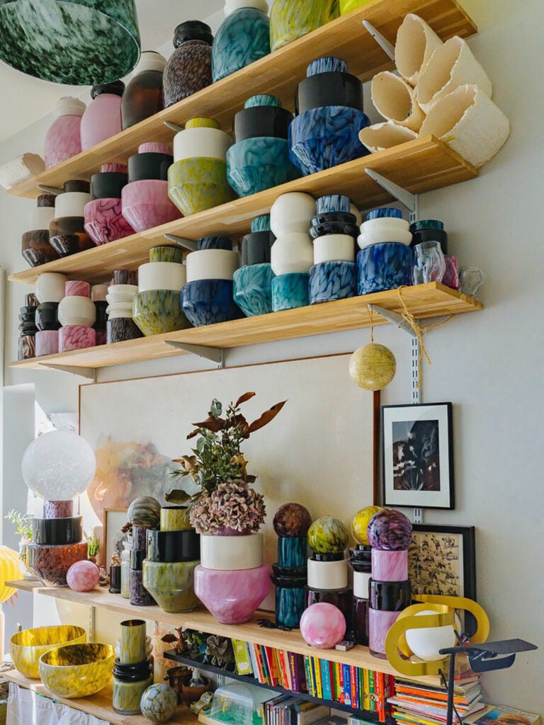 colorful vases layout on wooden shelves