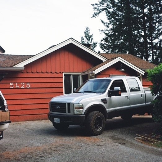 old red house with truck out front