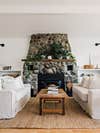 white sofas framing stone fireplace