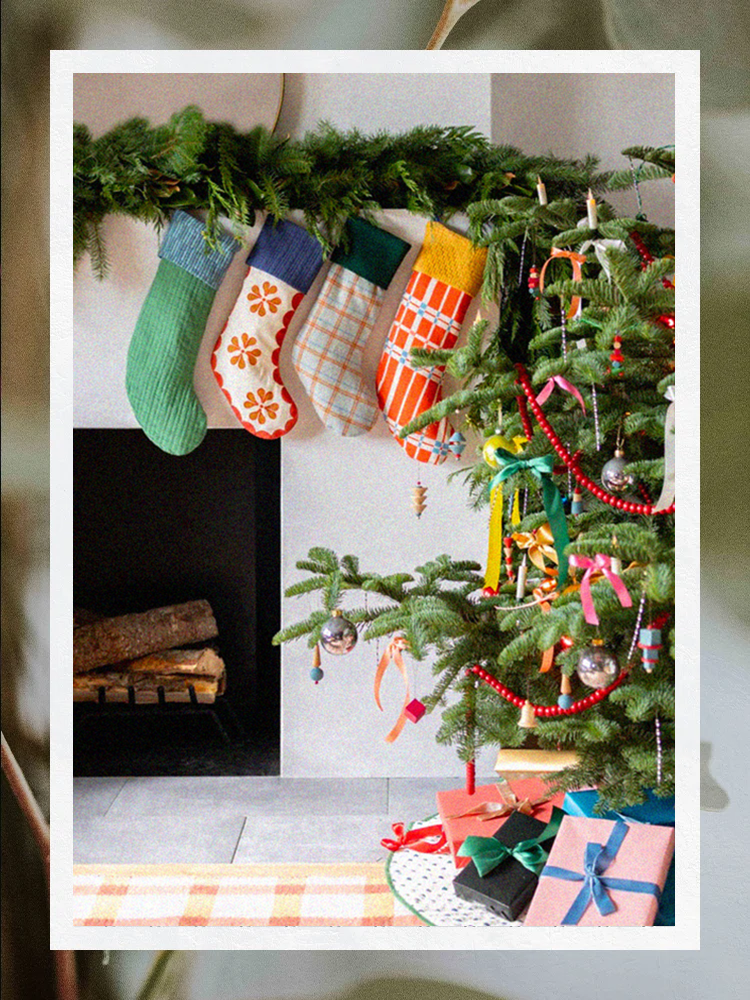 Schoolhouse stockings hung above fireplace next to Christmas tree