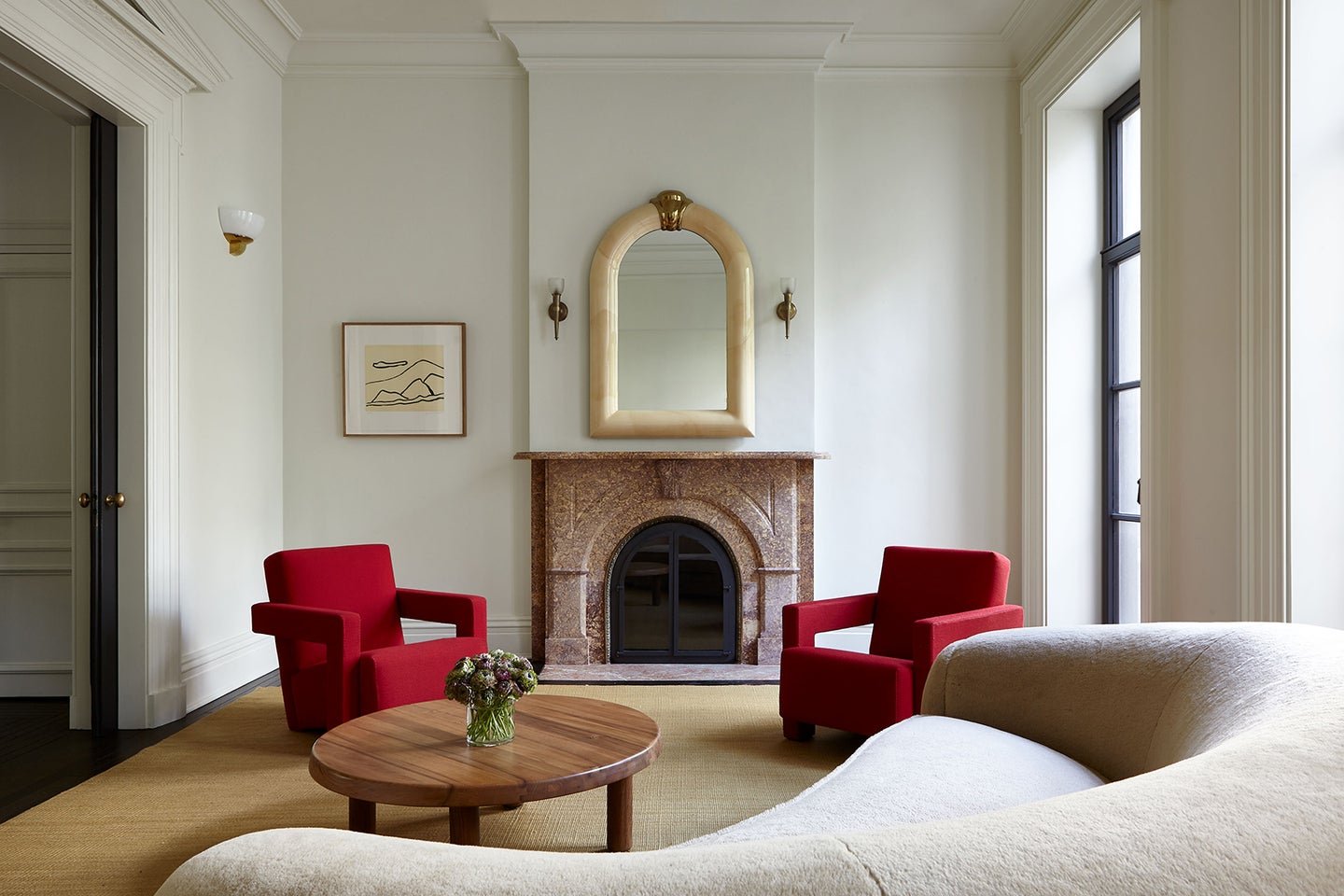 living room with fireplace and red armchairs